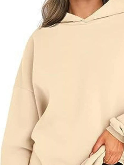 Beige hoodie worn by a person on a white background