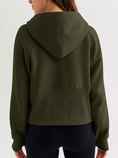 Person wearing a green hoodie from behind on a white background
