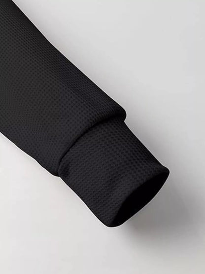 Black textured fabric roll on a light gray background
