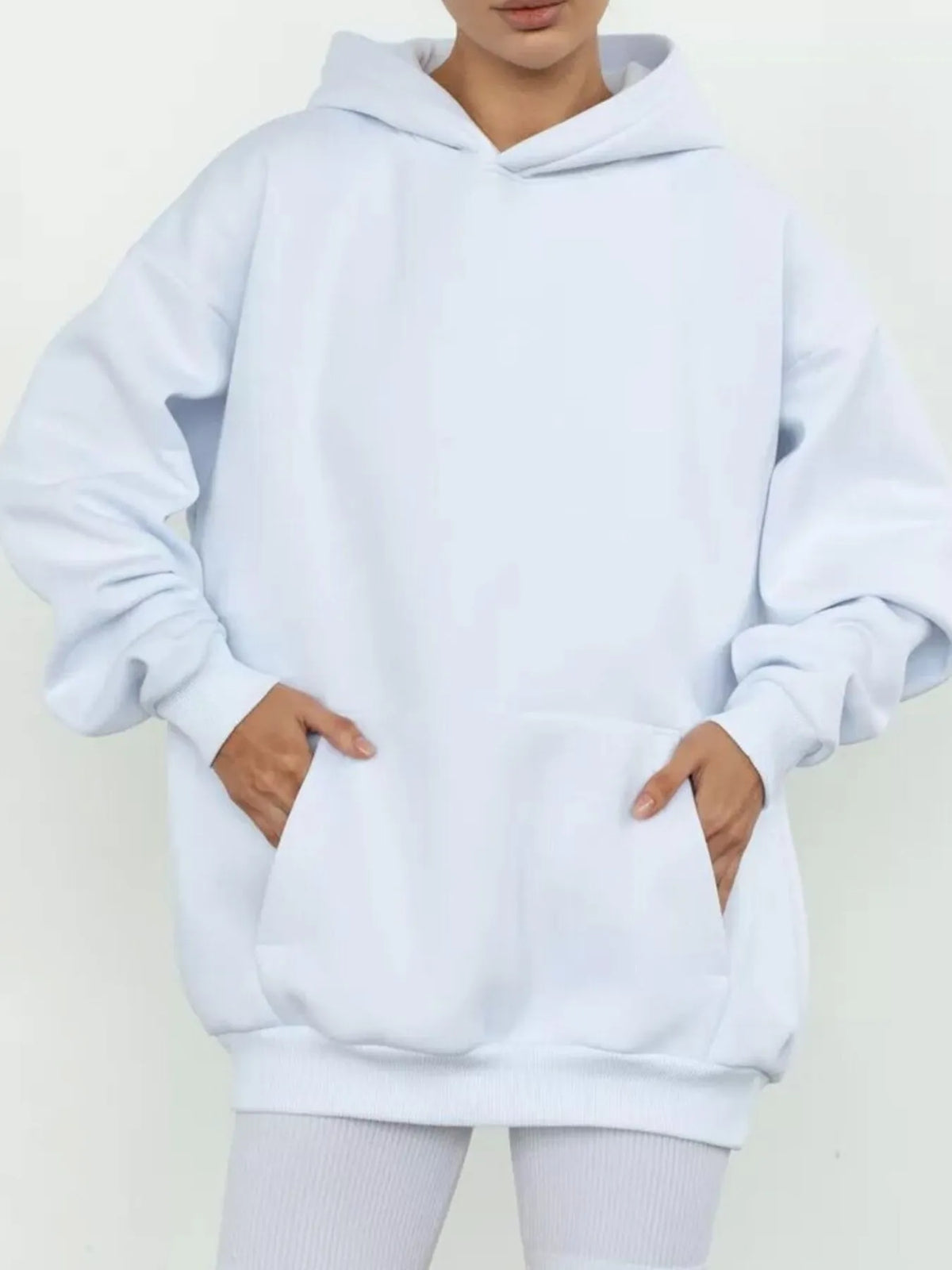 White hoodie worn by a person on a light gray background