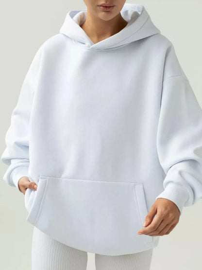 White hoodie worn by a person on a light gray background