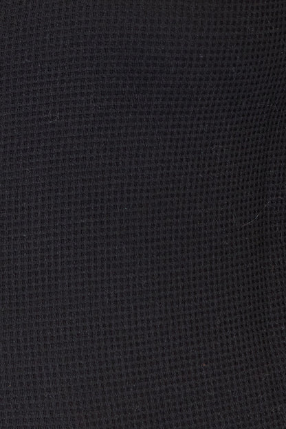 Close-up of a textured black fabric surface